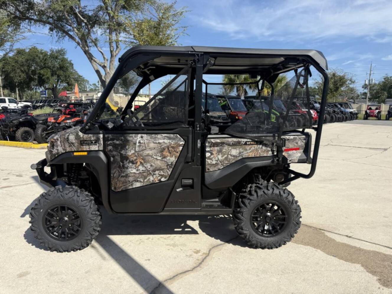 A photo of this 2026 Honda Pioneer 1000-5 Deluxe TrueTimber Atera Camo Deluxe