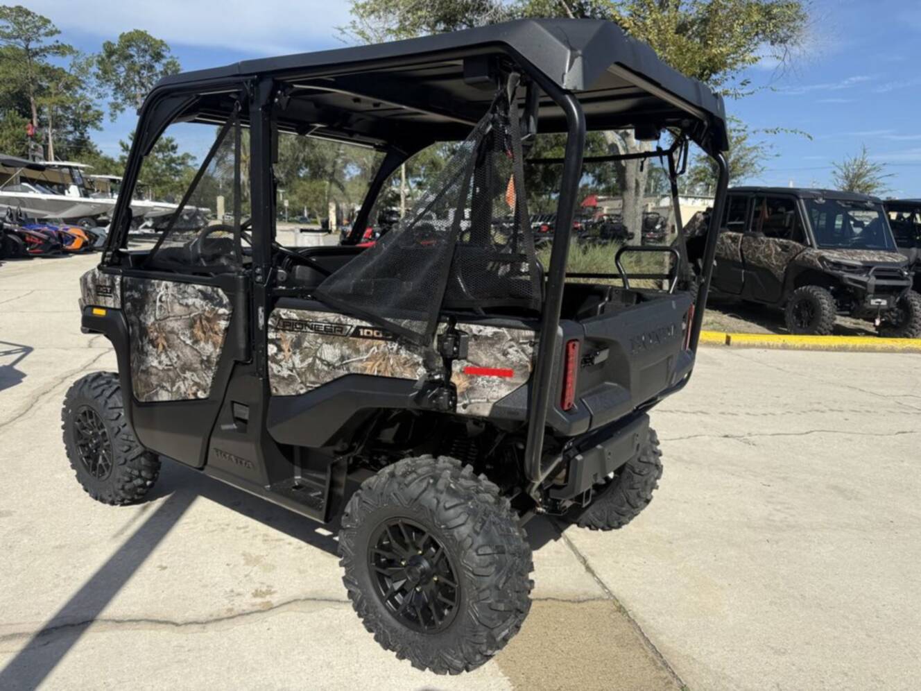 A photo of this 2026 Honda Pioneer 1000-5 Deluxe TrueTimber Atera Camo Deluxe