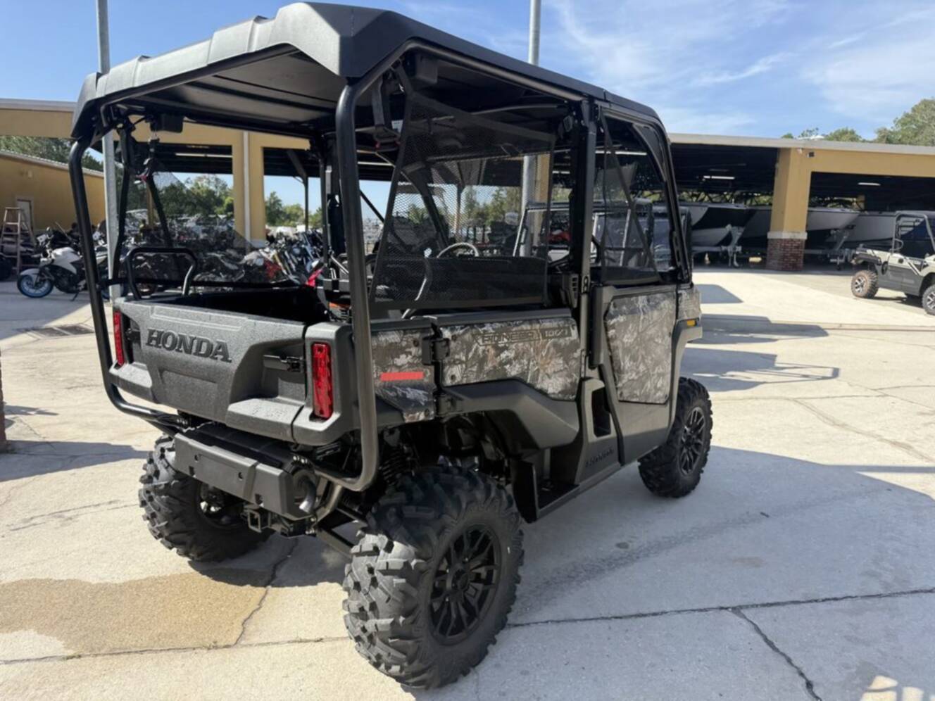 A photo of this 2026 Honda Pioneer 1000-5 Deluxe TrueTimber Atera Camo Deluxe