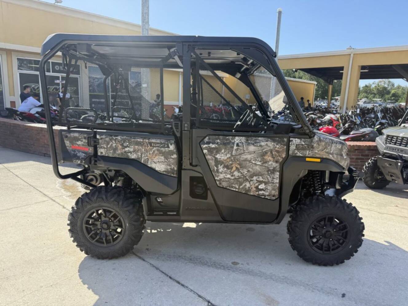 A photo of this 2026 Honda Pioneer 1000-5 Deluxe TrueTimber Atera Camo Deluxe