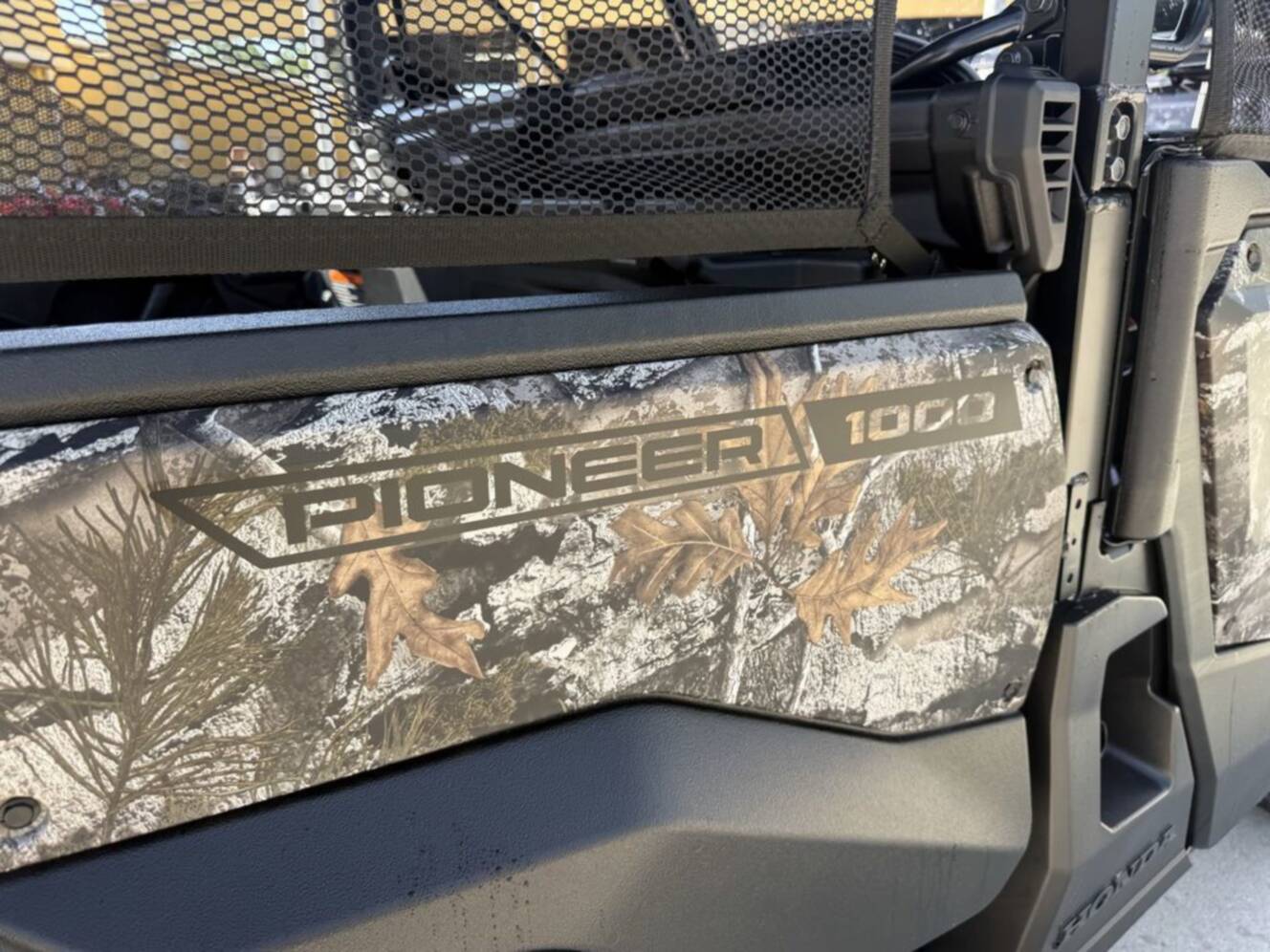 A photo of this 2026 Honda Pioneer 1000-5 Deluxe TrueTimber Atera Camo Deluxe