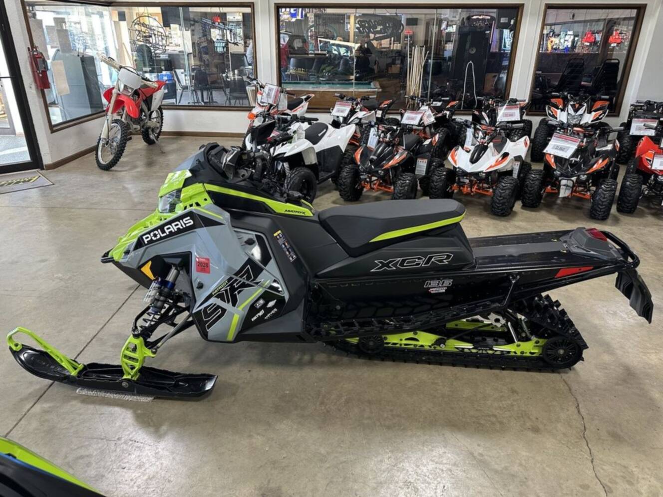 A photo of this 2025 Polaris® Patriot 9R Indy XCR 136 Storm Gray / Neon