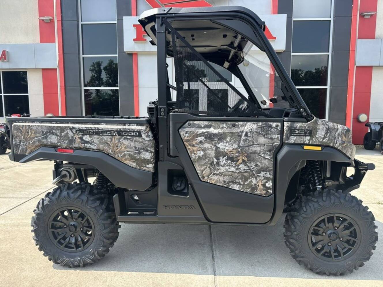 A photo of this 2026 Honda® Pioneer 1000 Deluxe TrueTimber atera camo