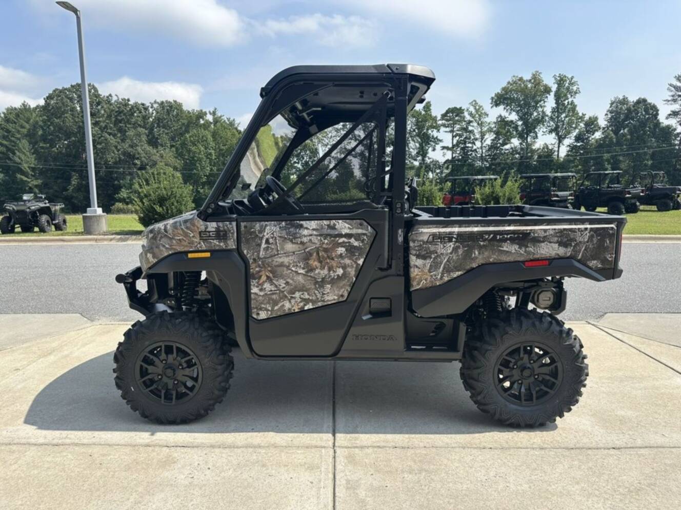 A photo of this 2026 Honda® Pioneer 1000 Deluxe TrueTimber atera camo