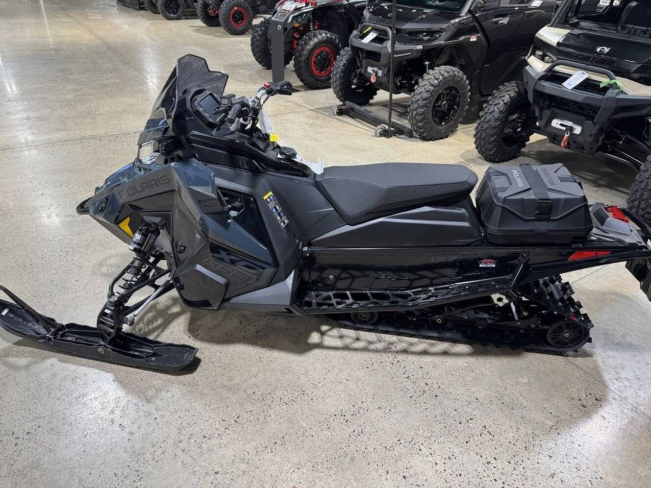 A photo of this 2026 Polaris® 850 PRO RMK 155 Gloss Black / Blue Dusk