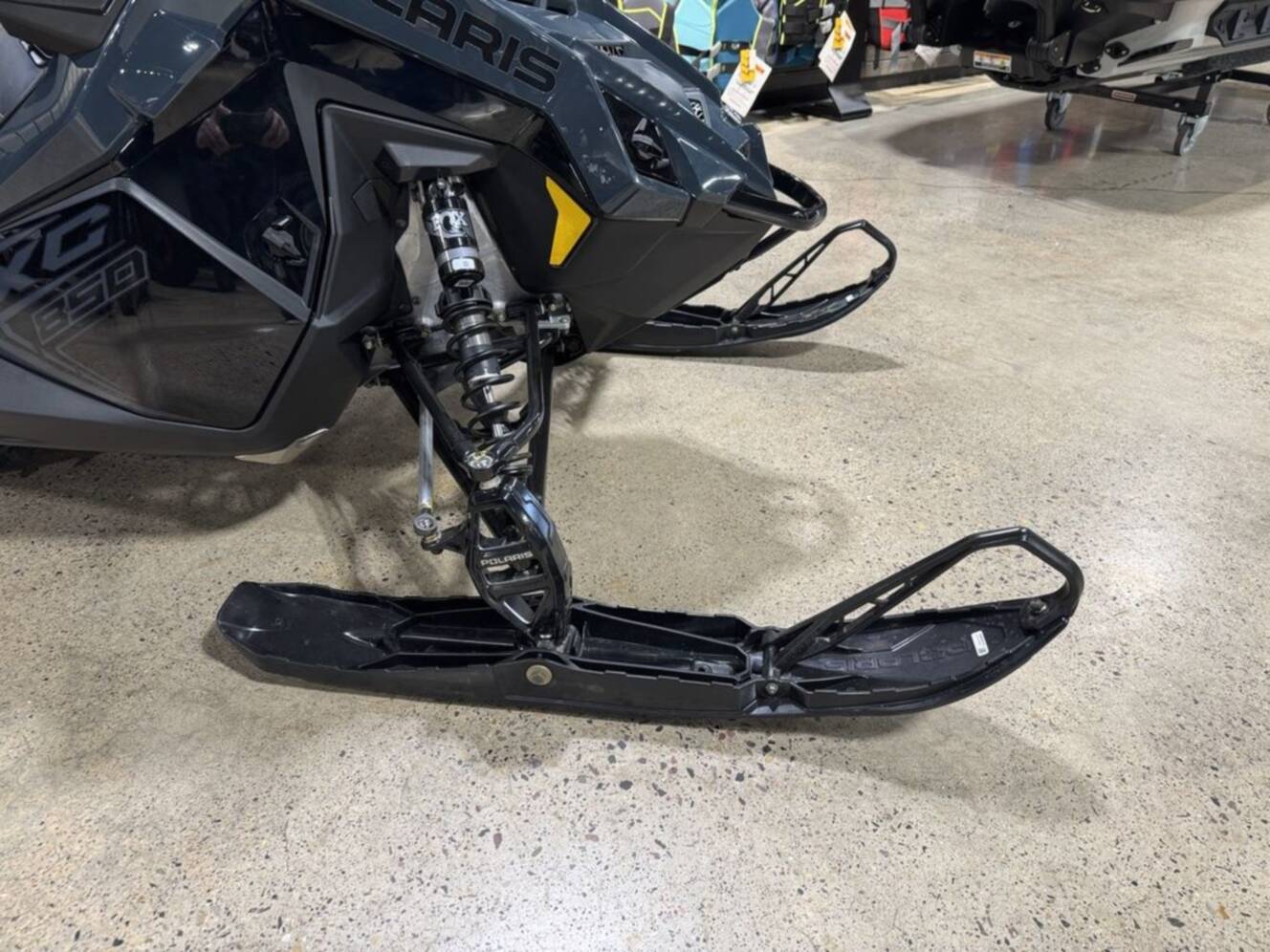 A photo of this 2026 Polaris® 850 PRO RMK 155 Gloss Black / Blue Dusk