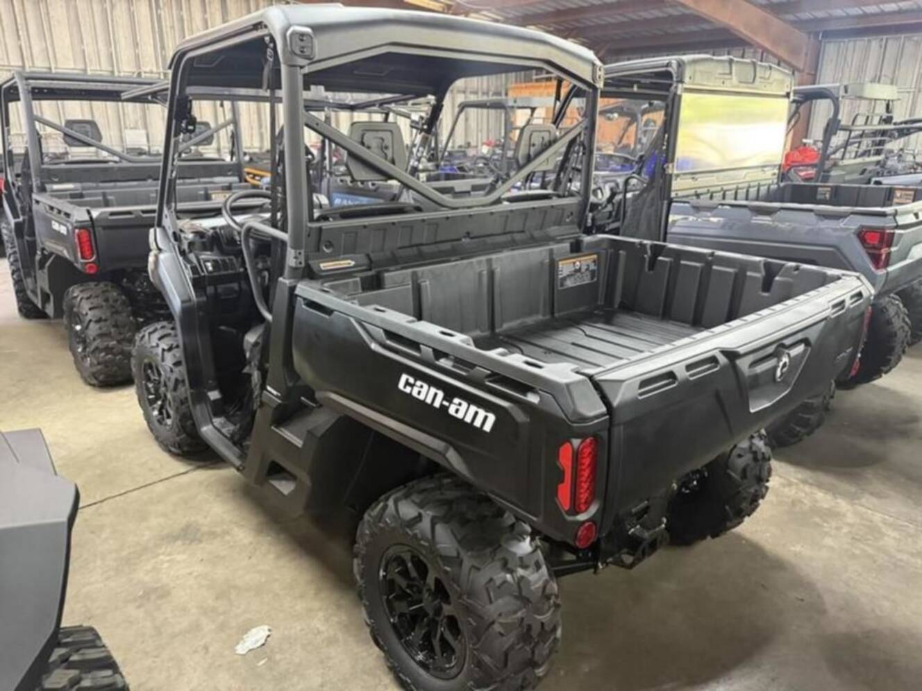 A photo of this 2026 Can-Am Defender DPS HD9 Dark Wildland Camo