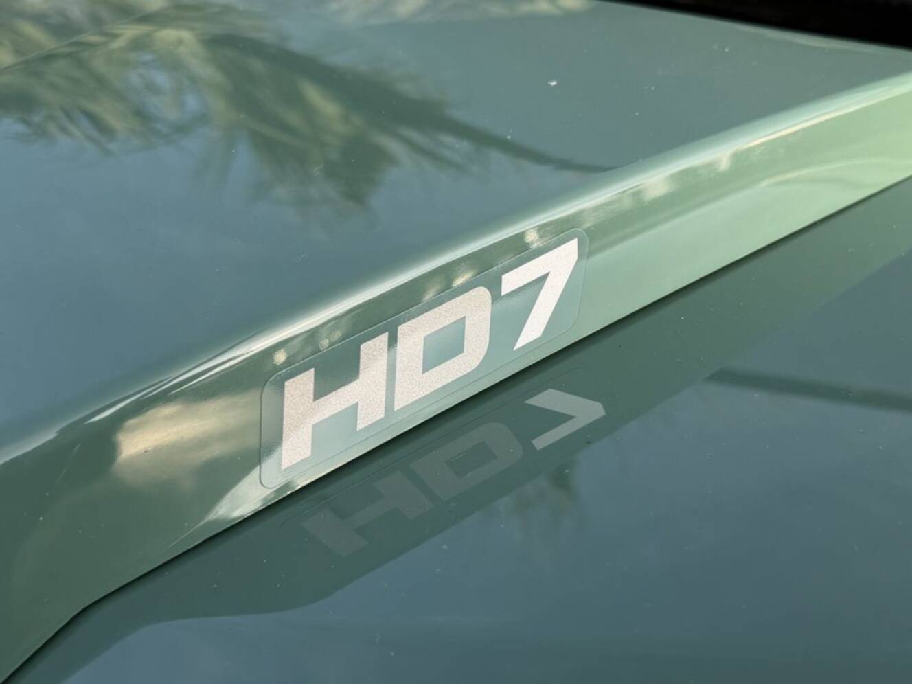 A photo of this 2026 Can-Am Defender DPS HD7 Compass Green