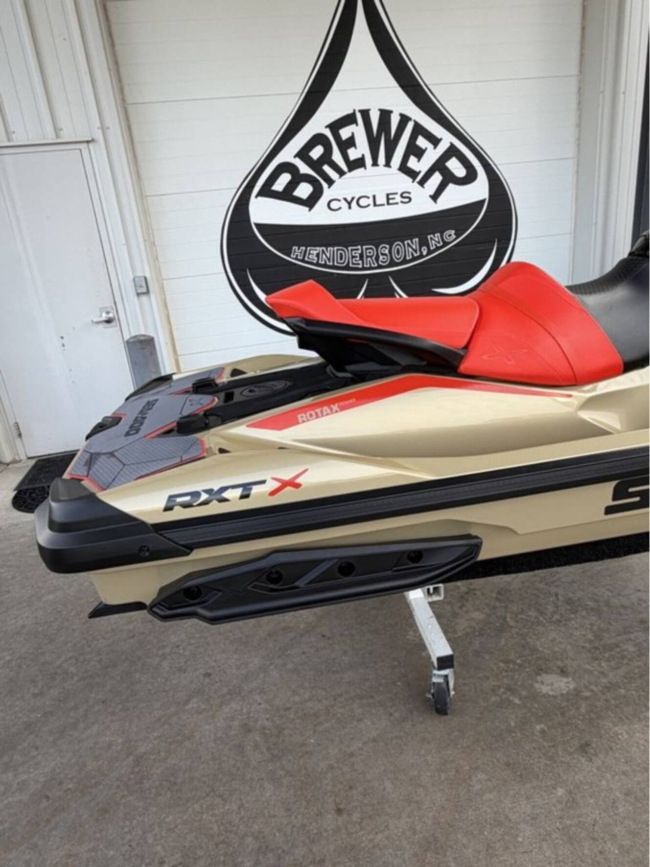 A photo of this 2025 Sea-Doo RXT-X 325 Metallic Tan / Lava Red Premium